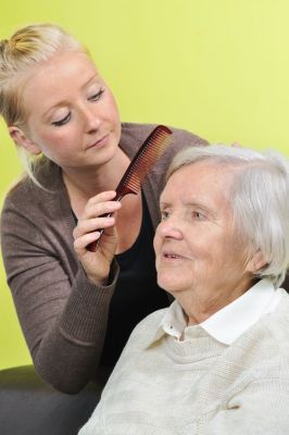 Caregiver combing a client's hair