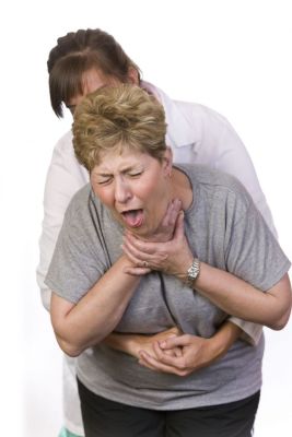 Woman doing the Heimlich maneuver