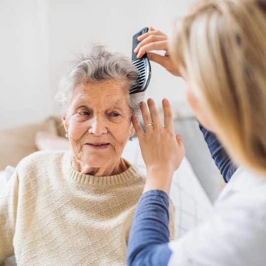 Caregiver brushing a client's hair